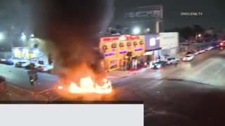 Cars go up in flames at downtown LA street takeover