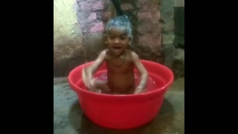 Cute baby in bathtub playing on bath