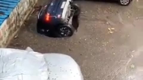 The pit swallows a car