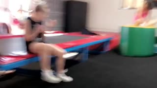 Girl back flips in trampoline folds