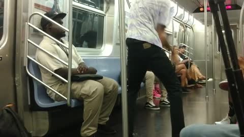 Contortionist dances to music on subway train,