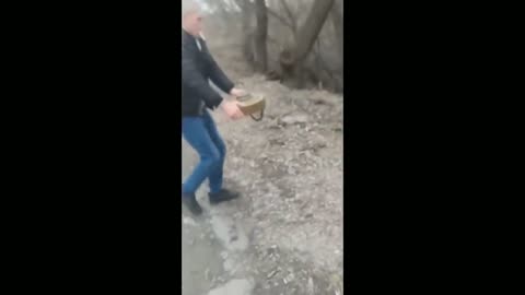 Russian war in Ukraine - Ukrainian civilian removes landmine from road without any fear