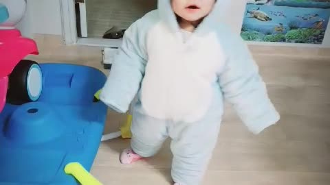 The cuteness of a baby in a blue bear suit