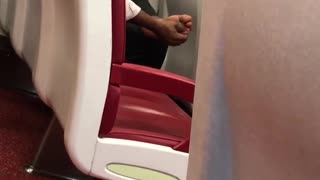 Train red seats person guy rubbing massaging feet