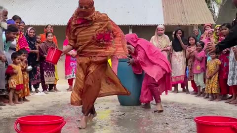 Filling the bucket with water from the drum is a fun game