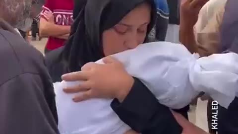 A mother says farewell to her son who was killed yesterday by Israeli Extremists