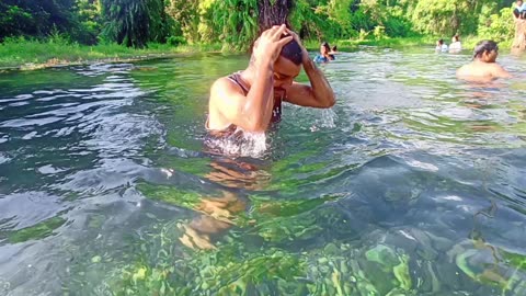 Taking bath in crystal river of india