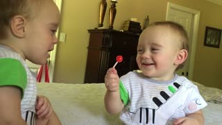 Baby Teases His Twin Brother with Lollipop