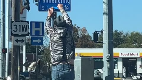 Panhandler Corrects Sign In Front Of Police