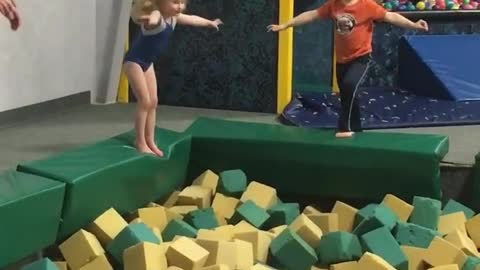 Collab copyright protection - boy lands on little girl in foam pit