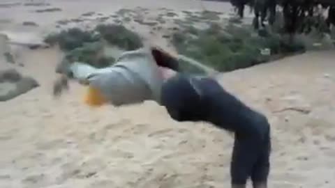 Guy yellow beanie backflip fail sand