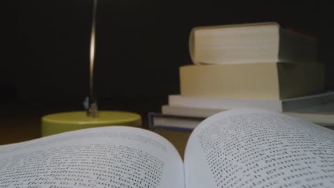 Tracking Close Up of Open Book on Table