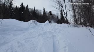 Skier does a jump off ramp and lands face first,