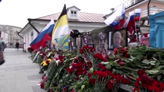 Russians lay flowers at makeshift Wagner memorial