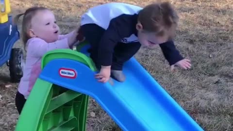 Collab copyright protection - girl pushes boy down blue slide