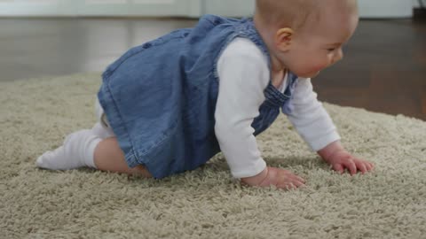 Baby girl learning to crawl before walking