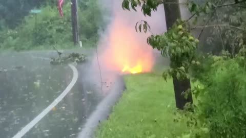Power line feeding back through a coax cable line on fire during storm.