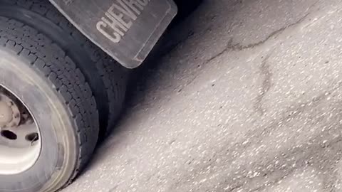 Smoking Truck Loses Tire in Traffic