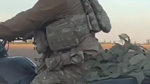 Ukrainian Soldier on ATV Transporting a Little Extra Junk