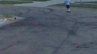 Little boy blue shirt scooter gos too fast and falls off