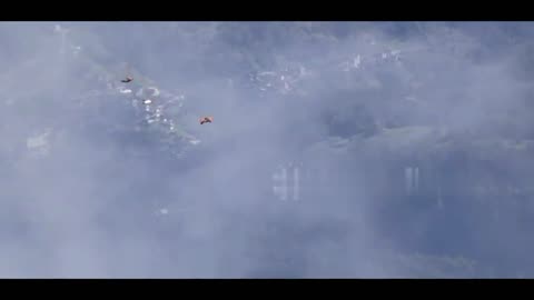 Three daredevil wingsuit flyers base jump off peak in Alps