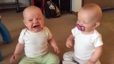 Twin baby fight for teether