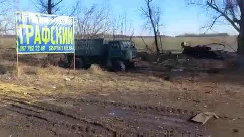 Destroyed military trucks & tanks smolder on the outside of villages.