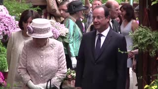 King Charles tours Parisian market named for mother