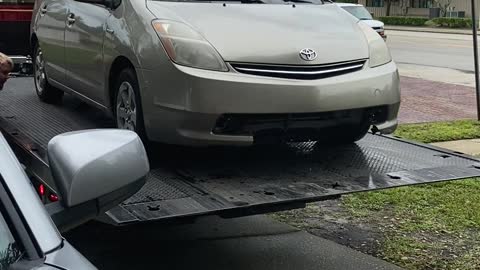 Tow Truck Driver Send Car Rolling Into Garage Door