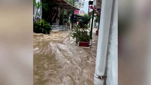 Water gushes down streets in Greece