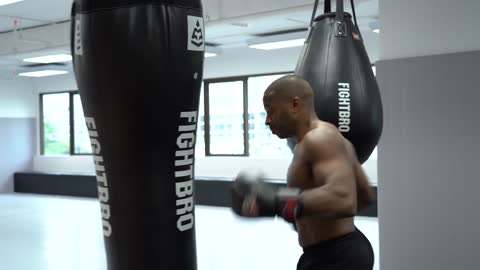 A Man Punching The Heavy Bag