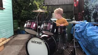 Adorable one-year-old loves playing the drums