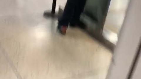 Man chilling at a train station with his pants half down, buttcheeks showing
