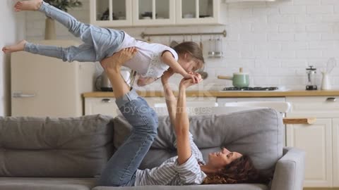 Happy attractive young mother lifting