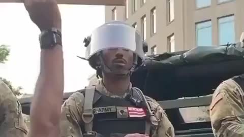 Protester elated to see soldier secretly protesting 'under his breath'