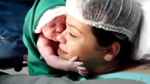 Mom's emotional moment Newborn baby clings to mom's face