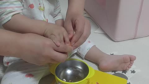 A baby who peels eggs by himself.