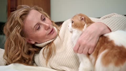 A Woman Petting Her Cat