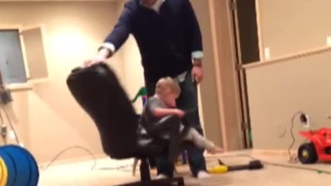 Funny Dad spins son in chair until he falls off from dizziness