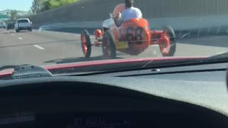 Passing by a 1930’s racecar on a busy freeway