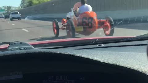 Passing by a 1930’s racecar on a busy freeway