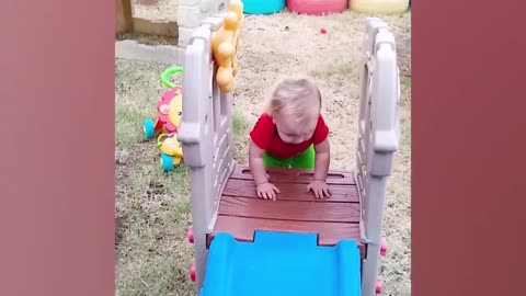 Funny baby's playing slide