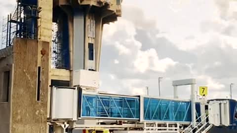 Slow motion footage of people working under the airport communication tower. WOW!!