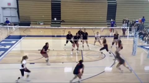 Volleyball player rolling to get out of the way