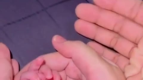Newborn baby showing middle finger while making emotional video