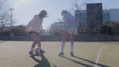 Four Female Friends Playing Soccer