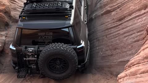 SUV climbing a steep rock