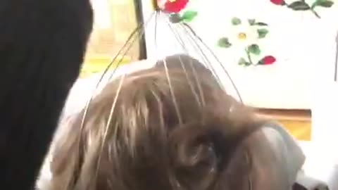 Toddler Enjoys Tickling by Scalp Massager