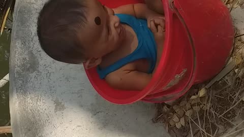 The baby didn’t want to get up from the bucket he was joking.