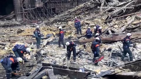 Russian rescuers work in ruins of destroyed concert hall